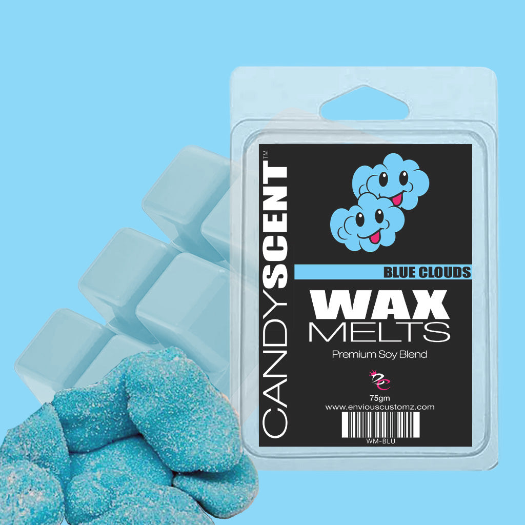 The image showcases a package of CANDYSCENT™ Wax Melts in Blue Clouds. The label is adorned with two cheerful, blue cloud illustrations along with the text "Blue Clouds" and "Premium Soy Blend." Complementing the package are blue, sugar-coated candy chunks and wax cubes that guarantee a fragrant paradise.