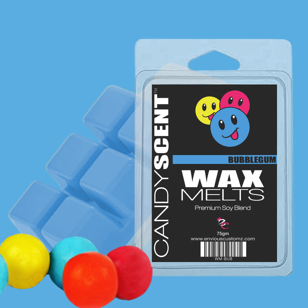 Photo of a CANDYSCENT™ Wax Melts packaging in bubblegum scent, adorned with colorful smiley faces and text. Alongside the unopened wax melts, yellow, turquoise, and red gumballs are arranged against a light blue background, crafting a fragrant paradise for your senses.