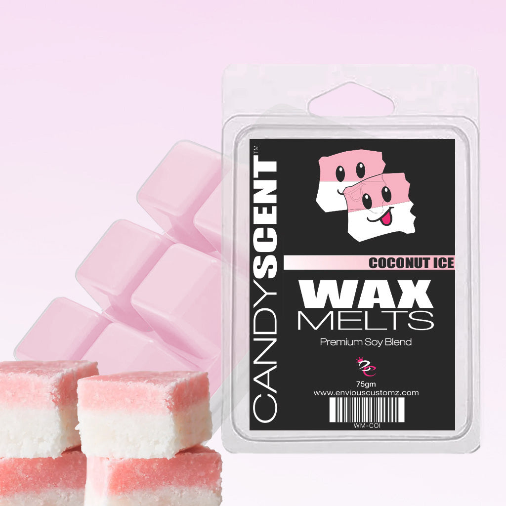 In the foreground, a package of CANDYSCENT™ Wax Melts, which offers a fragrant paradise with its pink and white coconut ice-scented wax cubes, is prominently displayed. Each package contains six highly scented wax melts. In the background, three squares of pink and white layered coconut ice candy can be seen on the side.