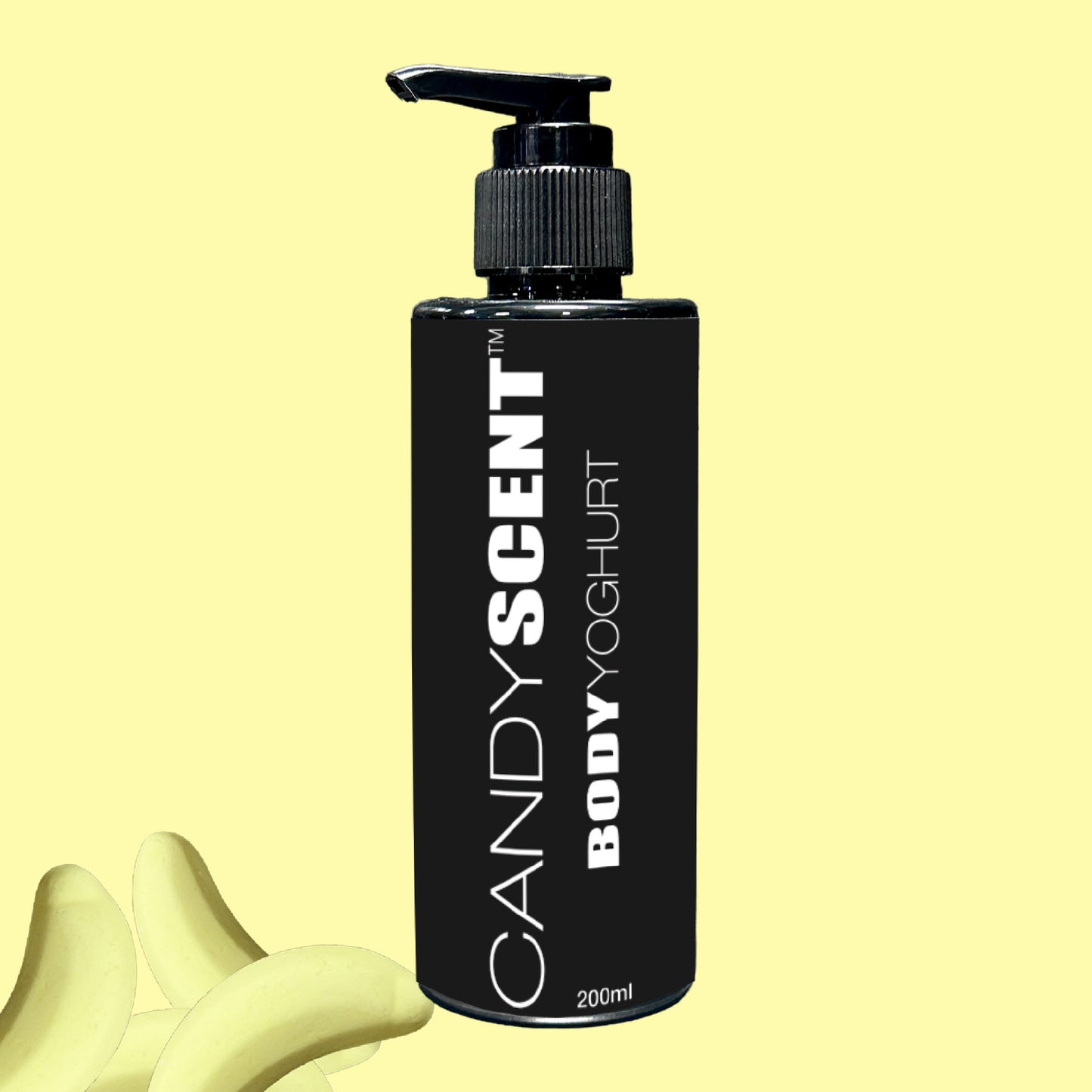 A black bottle featuring a pump dispenser and labeled "Body Yoghurt" by CANDYSCENT™ (200ml) provides a nourishing experience against a light yellow backdrop. At the base, banana-shaped pieces hint at deep hydration.
