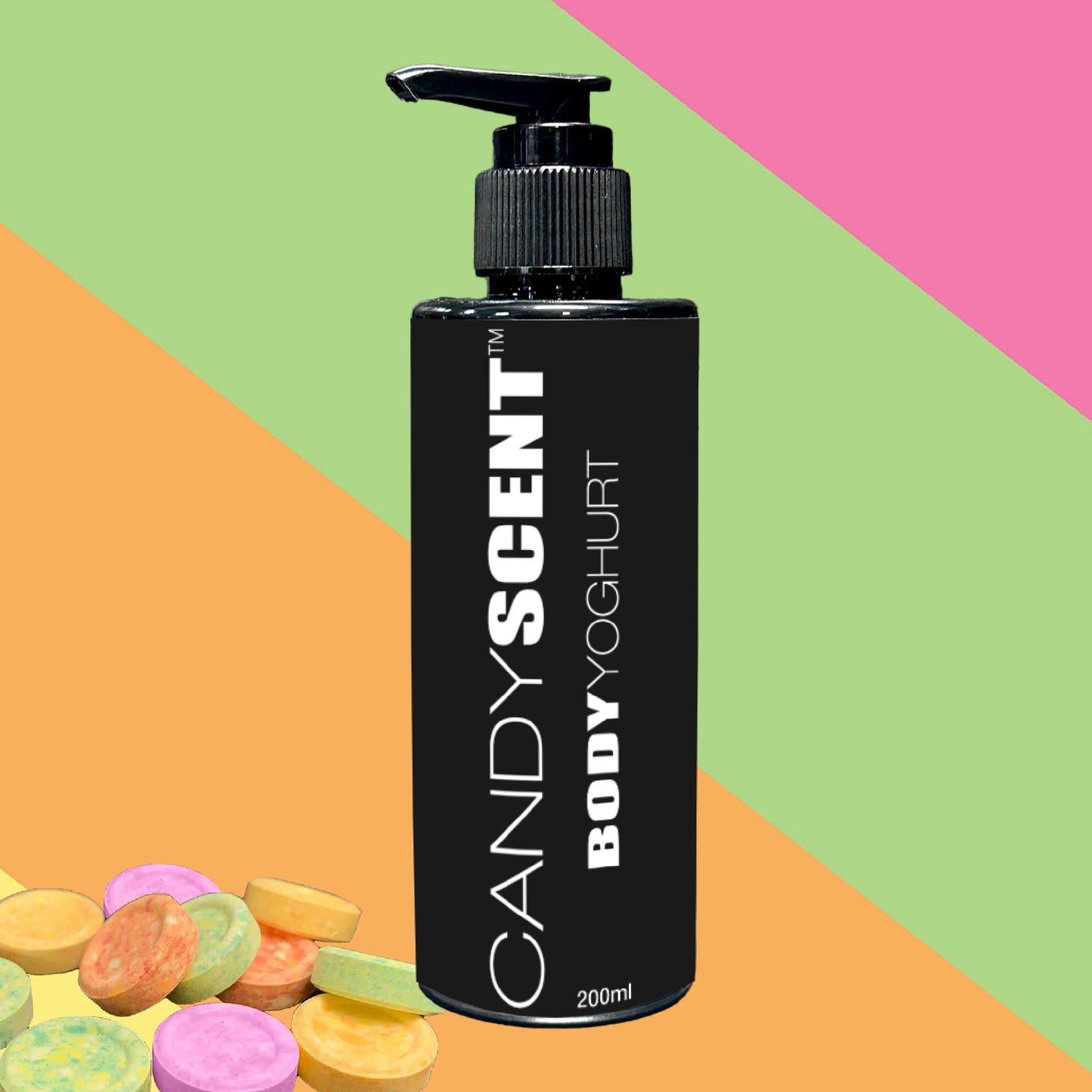 A black bottle labeled "CANDYSCENT™ Body Yoghurt" with a pump dispenser is set against a vibrant backdrop of pink, green, and orange. Assorted round candy pieces are scattered below, promising a nourishing experience for deep hydration.
