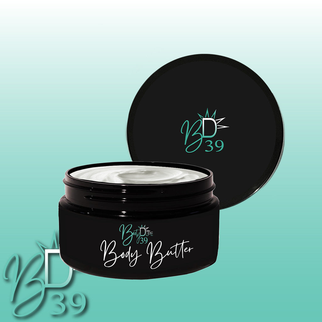 A black jar of BOOTY DUPE's "Body Butter" is open, showcasing the richly hydrating cream inside, with the lid placed behind it. The background transitions from light green to white, featuring the "BD39" logo in the lower left corner.