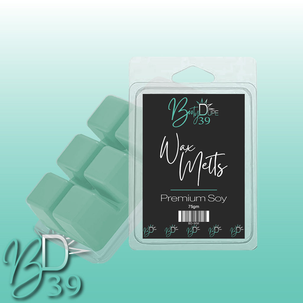 A package of BOOTY DUPE Soy Wax Melts, celebrated for its captivating fragrances, is housed in a clear plastic container with a black label. The package includes six highly scented teal cubes. The design features a gradient background flowing from teal to white, with the BD39 logo positioned in the bottom left corner.