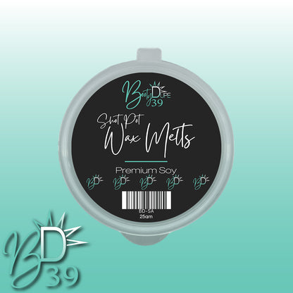 A round container labeled "Soy Wax Melts" from the brand BOOTY DUPE features a black top adorned with teal and white text. The enchanting fragrances of Body Dupe 39 are prominently displayed, alongside details like "Premium Soy" and size specifications. The backdrop boasts a calming gradient transitioning from teal to white.