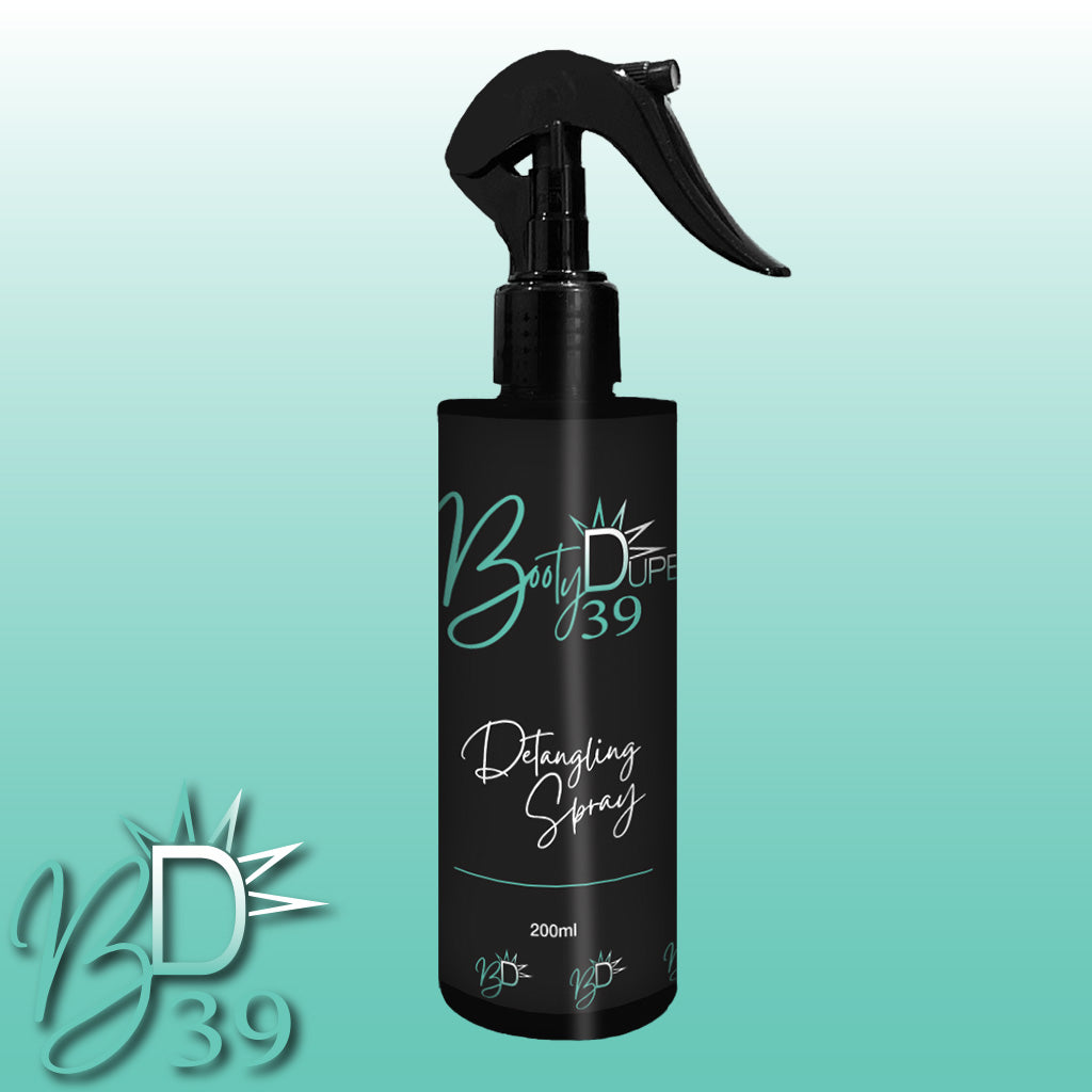 An image of a black spray bottle labeled "BOOTY DUPE Hair Detangling Spray" against a gradient turquoise background. The bottle has a trigger sprayer with the "BD39" logo shown in the bottom left corner of the image. Enriched with Aloe Vera and Jojoba Oil, it suits all hair types and contains 200ml of product.