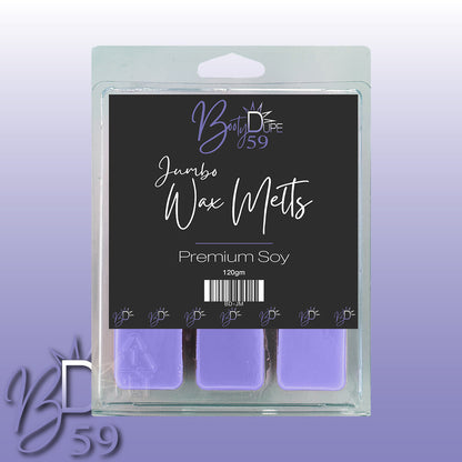 A transparent plastic container with a black label contains a pack of captivating purple jumbo wax melts. The label reads, "BOOTY DUPE Jumbo Wax Melts, Premium Soy, 120gm," with the background transitioning from white to purple.