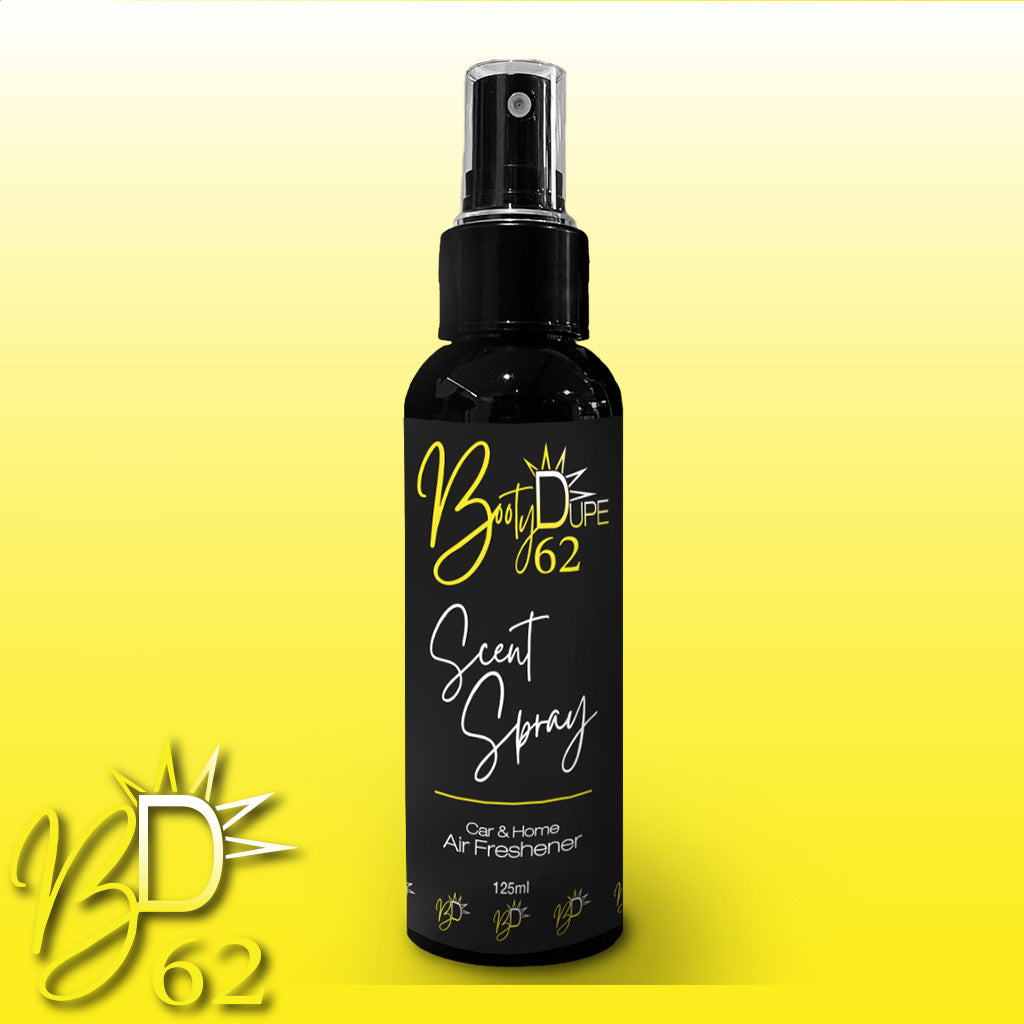 A 125ml black spray bottle of BOOTY DUPE Car & Home Scent Spray, designed to serve as both a car and home air freshener. The long-lasting fragrance effectively eliminates odours. The bottle features white and yellow text alongside a yellow logo that showcases a sun-like design with "B" and "D" in the centre, set against a yellow gradient background.