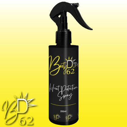 A black bottle of BOOTY DUPE Heat Protection Spray, 200ml, crafted for salon-quality results. It includes a spray nozzle and showcases stylized yellow and white text on a yellow gradient background, with an elegantly displayed logo in the bottom left corner.