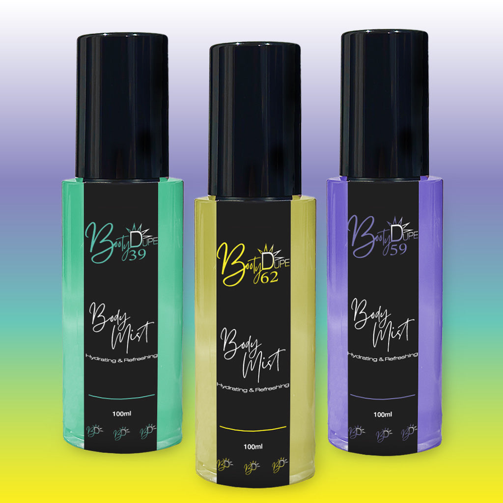 Three bottles of BOOTY DUPE Hydrating Body Mist are displayed against a gradient background. The green bottle is labeled Body Mist 039, the yellow bottle is labeled Body Mist 062, and the purple bottle is labeled Body Mist 059. Each 100ml hydrating mist features black caps and labels, offering a refreshing boost.