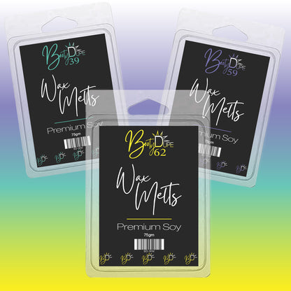 Three packages of highly scented Soy Wax Melts by BOOTY DUPE are displayed against a gradient background. Each package is labeled with "Body Be You-tique" and "Premium Soy, 75g." Immerse yourself in the captivating fragrances that transform any space into a soothing sanctuary.