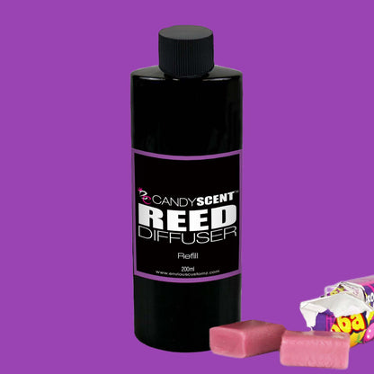 A black bottle labeled "CANDYSCENT™ Reed Diffusers & Refills" against a purple background. The Australian-made bottle is 200ml in size. Two pieces of pink chewable candy and an unwrapped candy wrapper are placed beside the bottle, hinting at the long-lasting fragrance within.