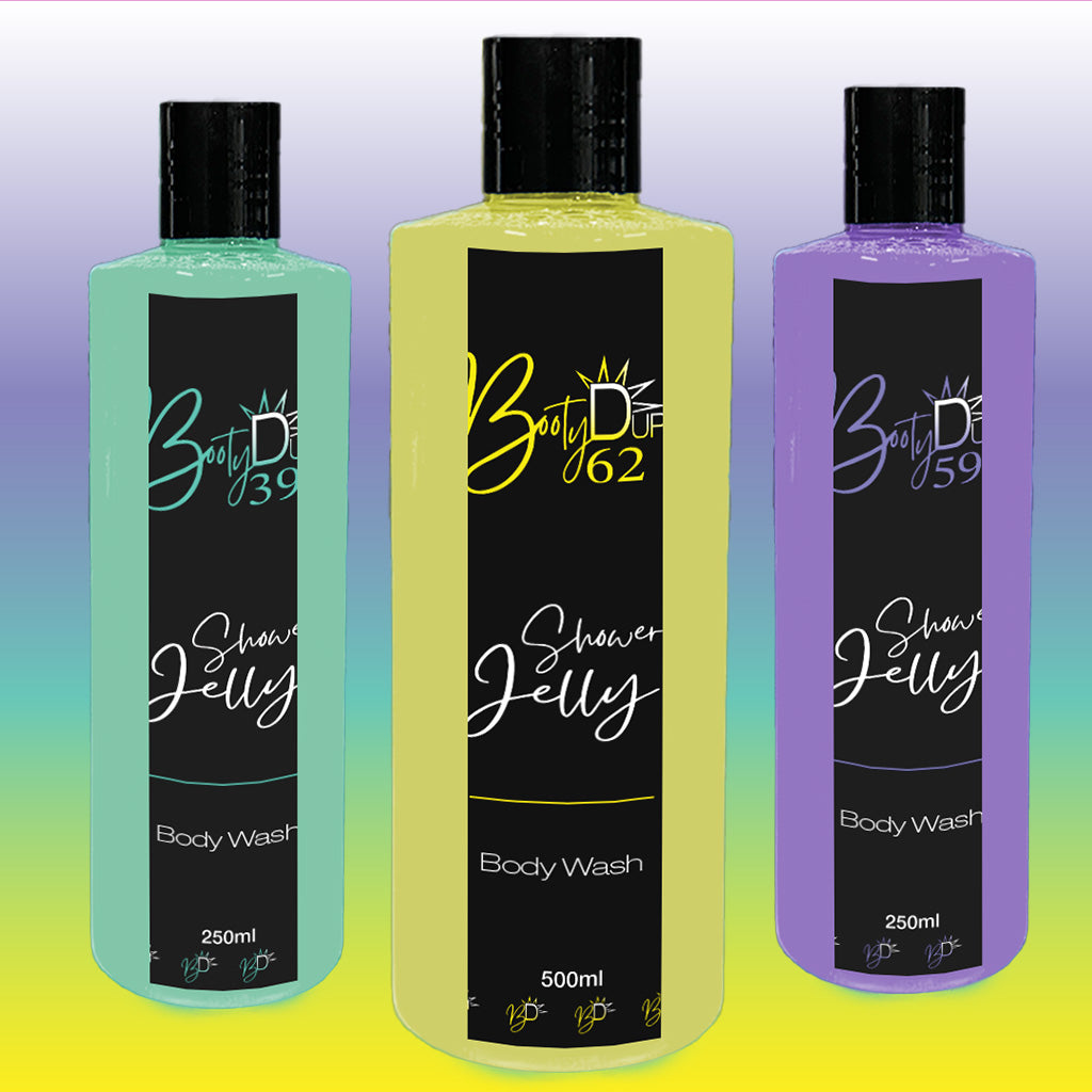 This image showcases three bottles of BOOTY DUPE Shower Jelly Body Wash. The bottles are colored light green, yellow, and purple, each with black labels containing the text 