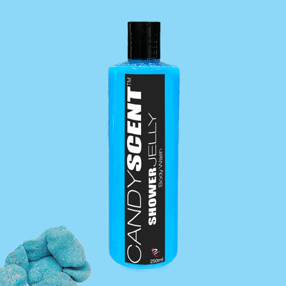 A blue bottle of CANDYSCENT™ Shower Jelly Body Wash set against a light blue background, with a small cluster of blue candy pieces in the bottom left corner. The bottle features a black cap and a black rectangular label with "CANDYSCENT™ Shower Jelly Body Wash" in white text, promising a nourishing body cleanser and luxurious shower experience.