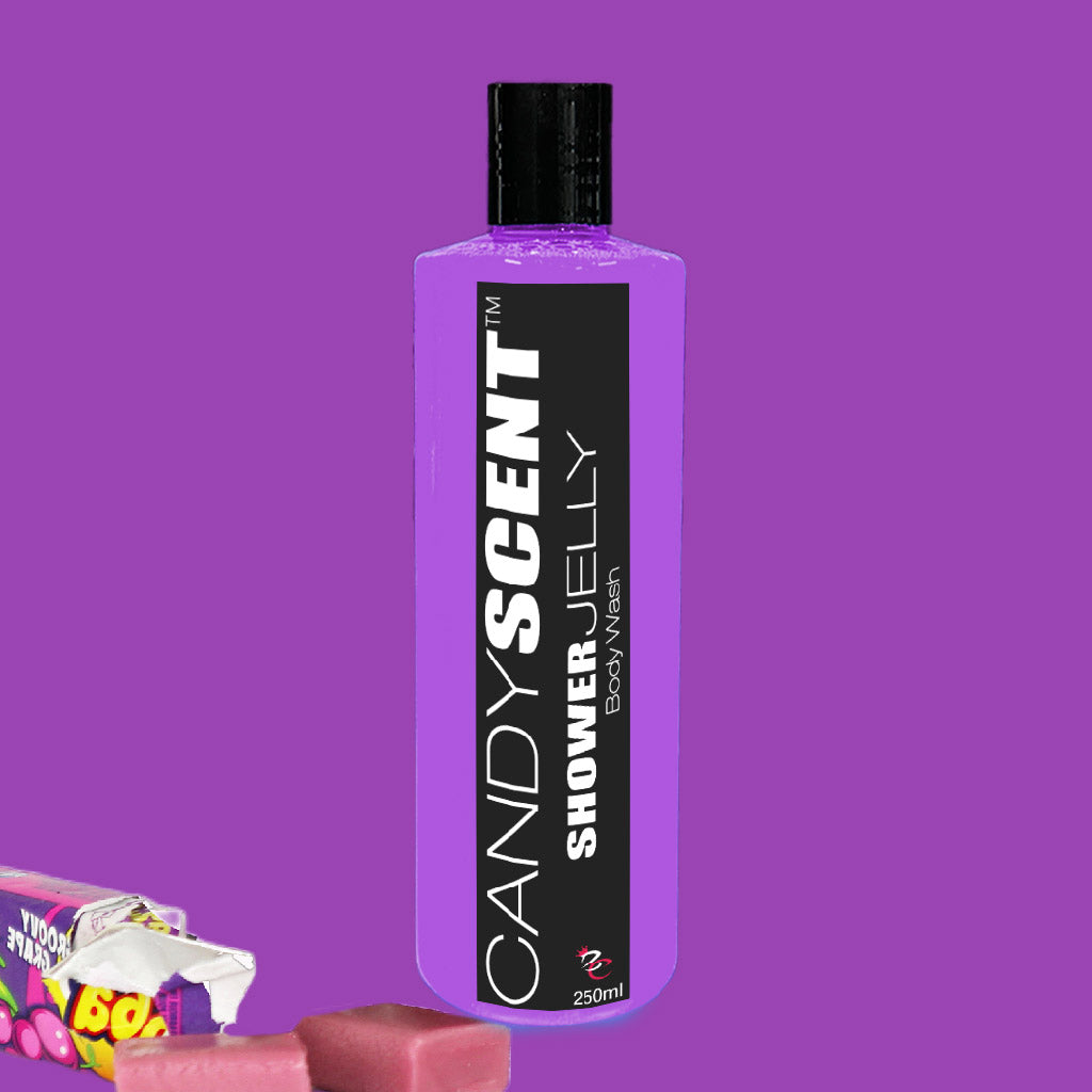 A bottle of Shower Jelly Body Wash from CANDYSCENT™, in a vibrant purple hue, is displayed against a corresponding purple backdrop. The rectangular container features a black cap and label, suggesting an indulgent shower experience. The bottom left corner of the image is adorned with pieces of pink-wrapped candy.