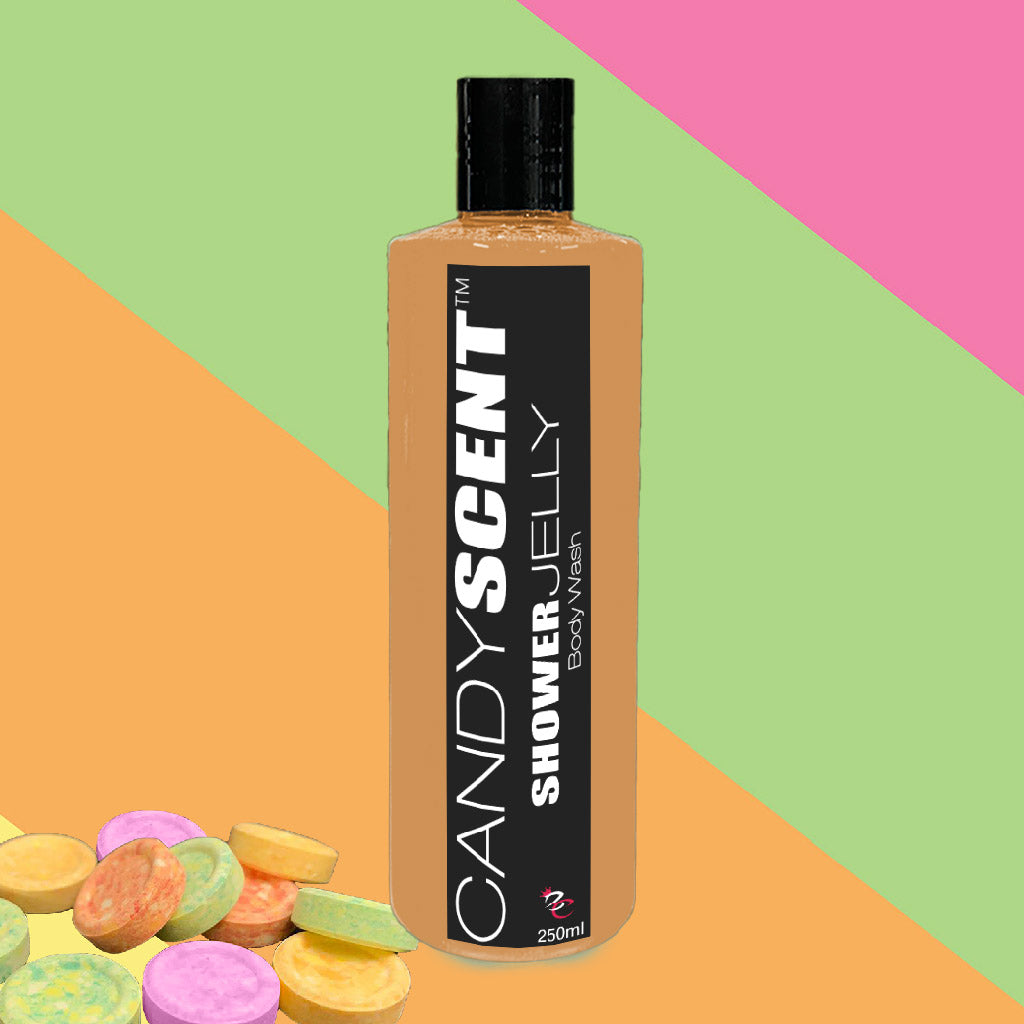 A bottle of CANDYSCENT™ Shower Jelly Body Wash is showcased against a vibrant backdrop of pink, green, and orange diagonal stripes. Various colorful candy-like discs are scattered at the bottom left corner of the image. The bottle contains 250ml of product.