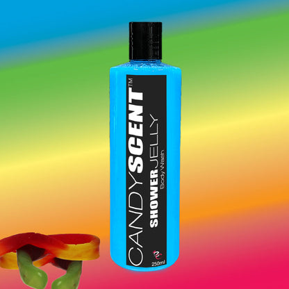 A blue bottle of CANDYSCENT™ Shower Jelly Body Wash, featuring a black label, stands against a vibrant rainbow background. A piece of red and green gummy candy rests at the bottom left corner, hinting at the luxurious shower experience this moisturizing wash promises.