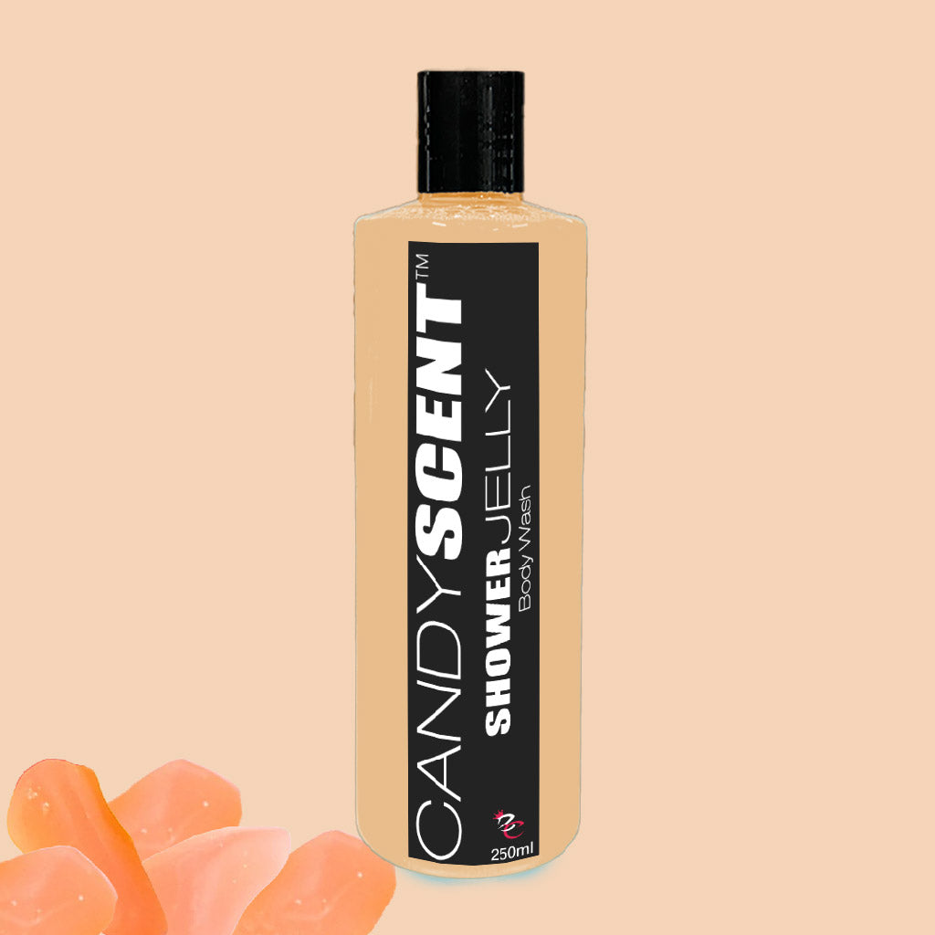 A 250 ml bottle of CANDYSCENT™ Shower Jelly Body Wash is displayed against a beige background. The beige bottle features a black label with white text. Several pieces of translucent pink shower jelly at the bottom left corner highlight its moisturizing properties.