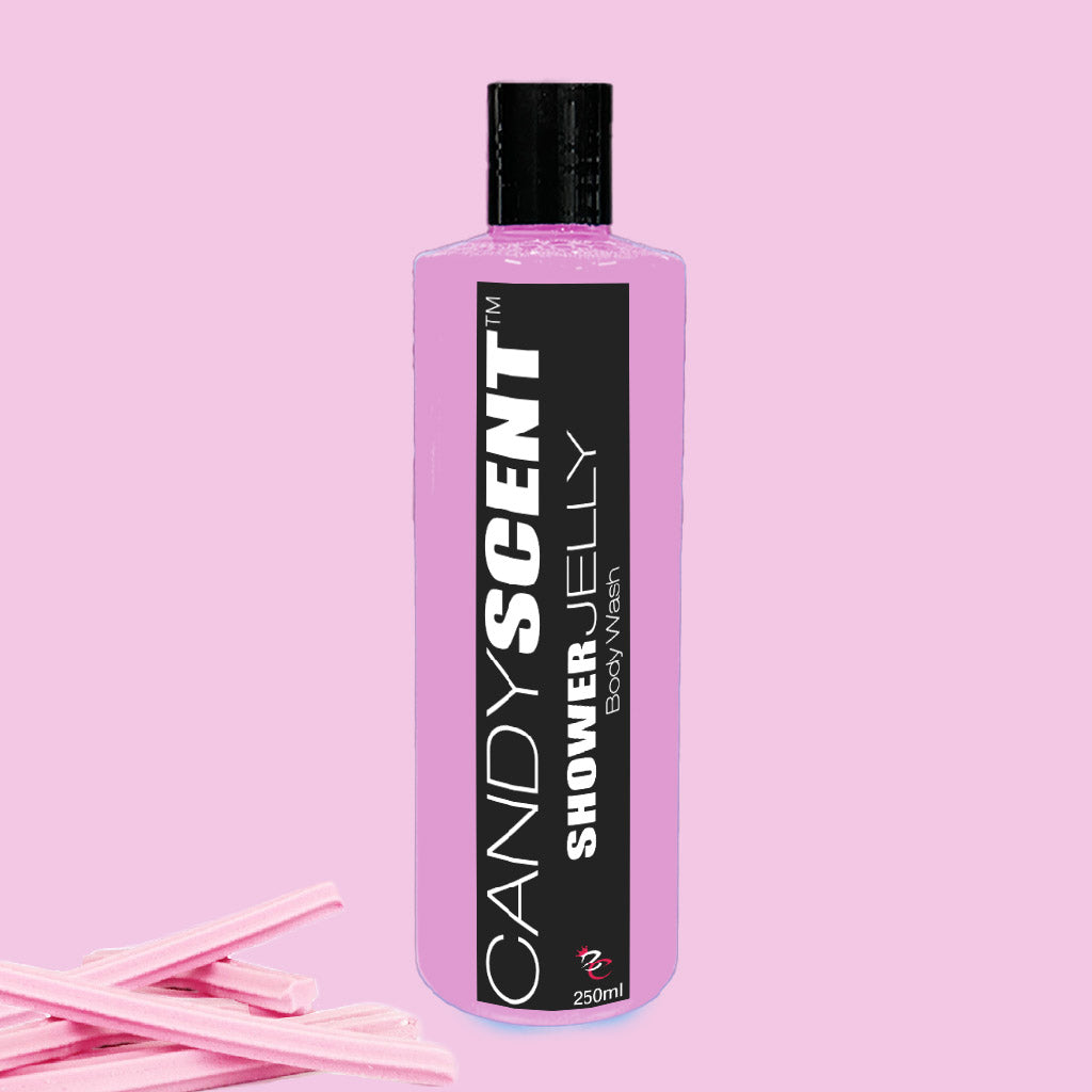 A 250ml bottle of CANDYSCENT™ Shower Jelly Body Wash featuring a black label with white text on a pink background. The nourishing body cleanser inside appears pink. To the left of the bottle, there are small pieces of pink candy sticks, enhancing the luxurious shower experience.