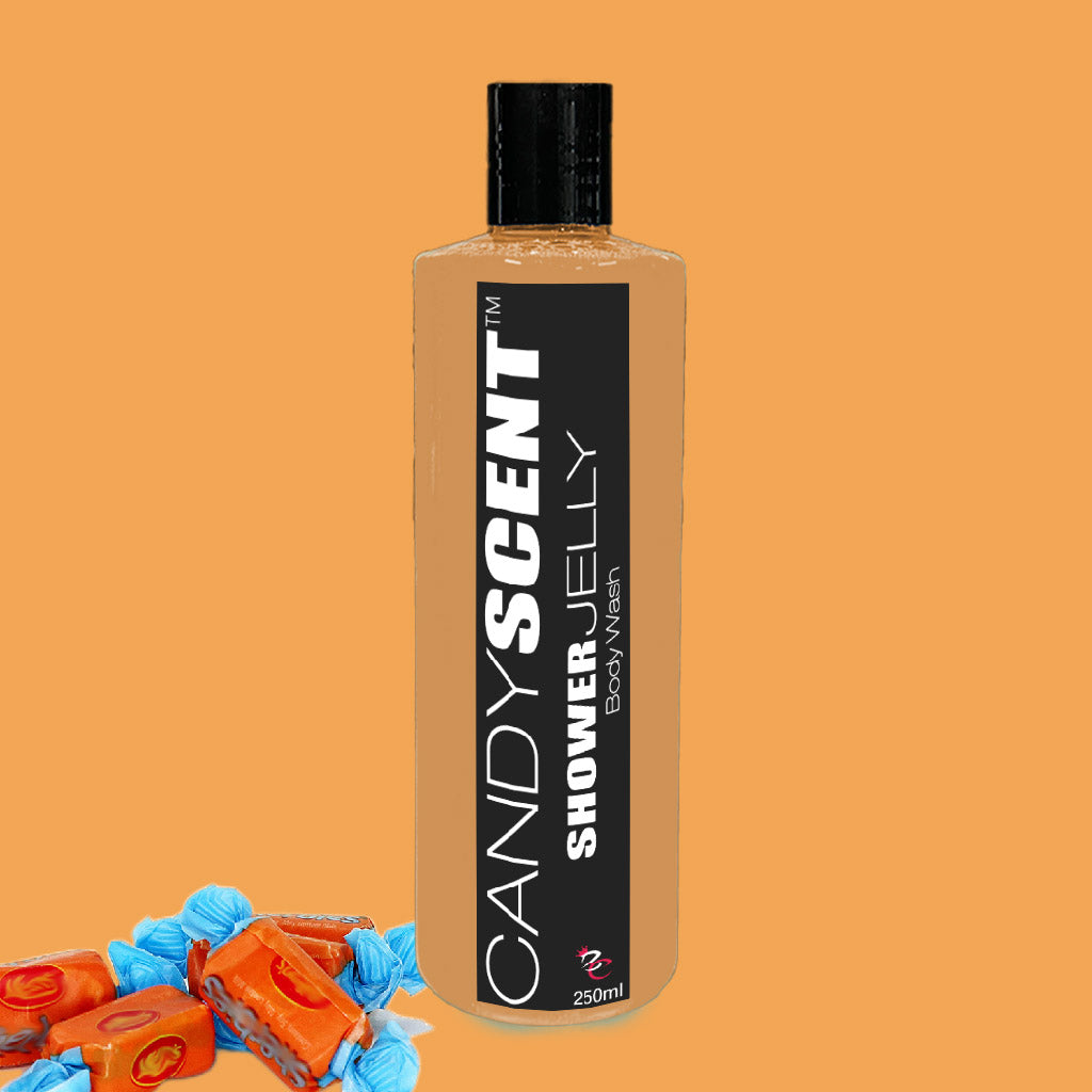 A 250ml bottle of CANDYSCENT™ Shower Jelly Body Wash features an orange liquid inside. Its black label with white text accentuates the luxurious shower experience, while brightly wrapped orange candies beside the bottle on an orange background hint at its sweet, nourishing body cleanser formula.