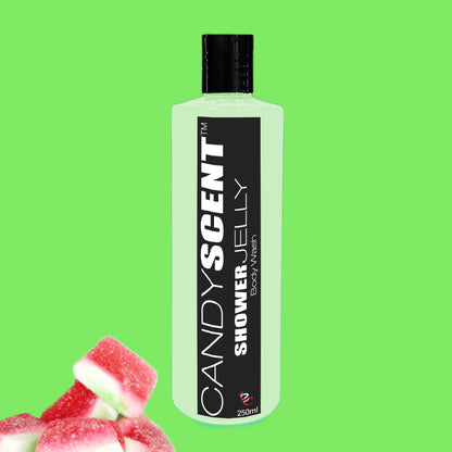 A bottle of Shower Jelly Body Wash by CANDYSCENT™ stands against a vibrant green background. The translucent bottle, labeled with black and capped in black, contains 250ml. Pink and white candy pieces are scattered in the bottom left corner.
