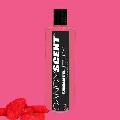 A 250ml bottle of CANDYSCENT™ Shower Jelly Body Wash with a pink liquid inside, set against a pink background. The black label reads "CANDYSCENT™ Moisturising Shower Jelly Body Wash." Red candy pieces are placed near the bottom left corner.