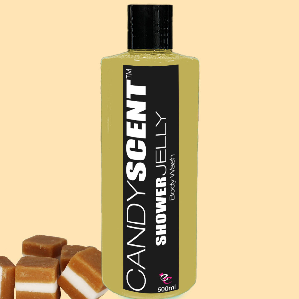 A bottle of CANDYSCENT™ Shower Jelly Body Wash with yellow liquid and a black label featuring the product name and quantity (500ml). Several caramel-colored jelly cubes are visible at the bottom left corner. The background is beige.