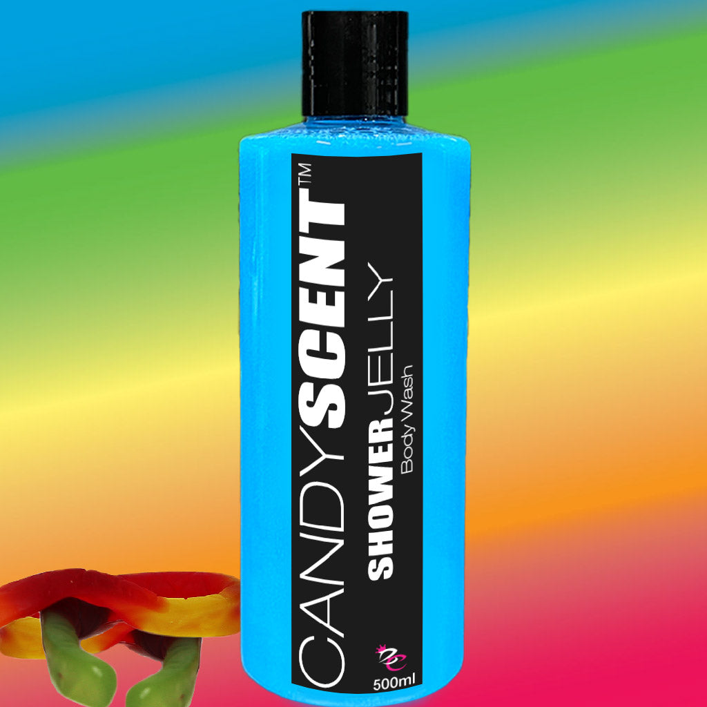 A bottle of CANDYSCENT™ Shower Jelly Body Wash is set against a vibrant, multicolored background. The bright blue bottle with a black label and white text exudes energy. In the bottom left corner, a partial view of colorful gummy candy hints at its sweet aroma. The 500ml size promises lasting moisturizing care.