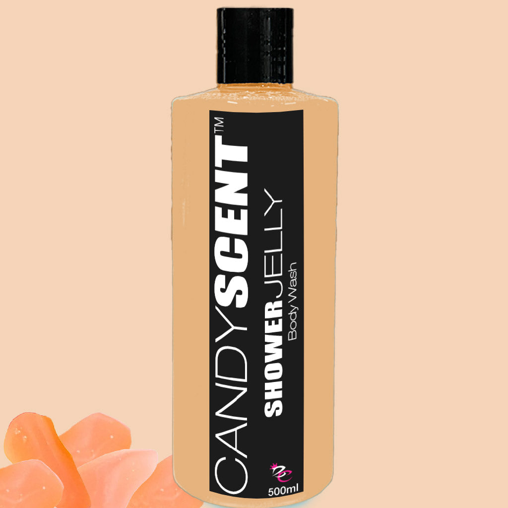 A 500ml bottle of CANDYSCENT™ Shower Jelly Body Wash features a black cap and a label with white text set against a beige background. Small chunks of orange shower jelly are visible near the bottle's base.