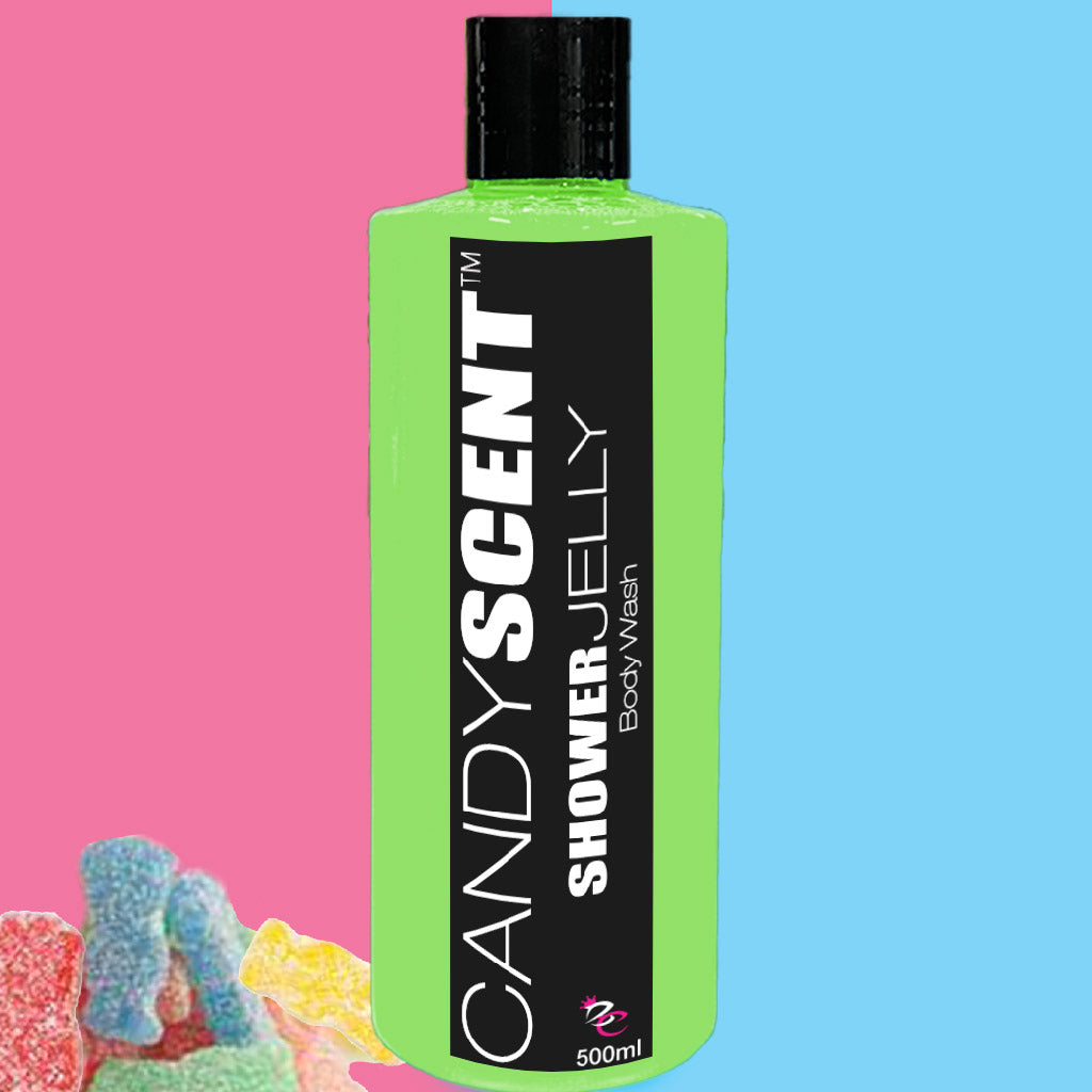 A green bottle of CANDYSCENT™ Shower Jelly Body Wash takes center stage. Its label displays bold black text. The background is split, with pastel pink on the left and sky blue on the right. Gummy candies peek out from the bottom left corner, suggesting a luxurious shower experience.