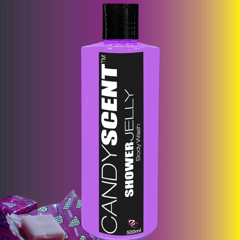 A 500ml bottle of CANDYSCENT™ Shower Jelly Body Wash, featuring a purple-colored, moisturizing liquid. The bottle sports a black label with bold white text on a gradient background of purple, yellow, and gray. Small, partially visible candy wrappers embellish the bottom left corner.