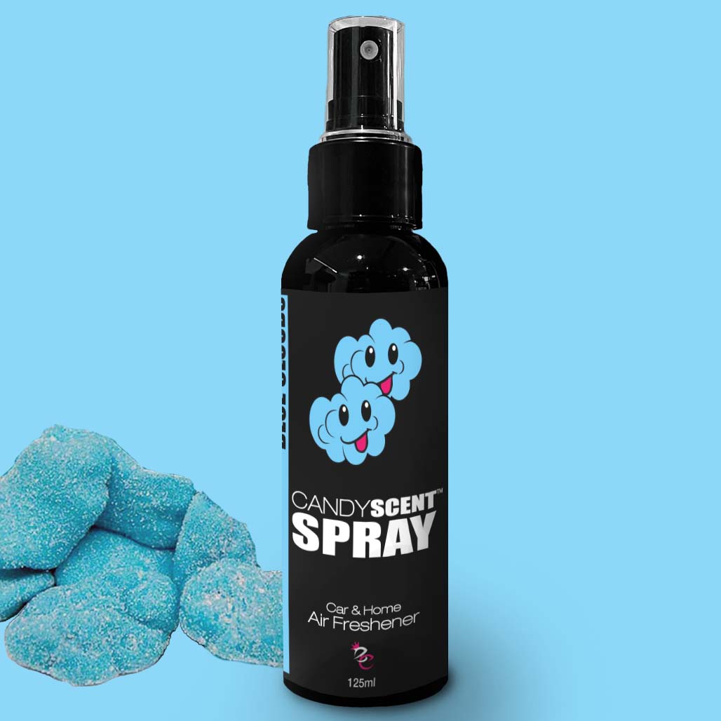 A 125ml black spray bottle labeled "Car & Home Scent Sprays" by CANDYSCENT™, featuring a cartoon cloud design on a blue background. The air freshener, ideal for eliminating odors, is placed next to a pile of blue, sugar-coated candy pieces. Enjoy the long-lasting fragrance in your car or home!