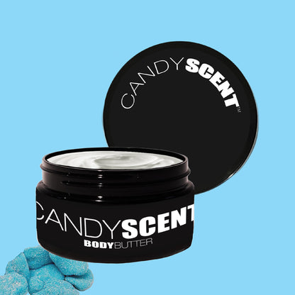 A black jar of CANDYSCENT™ Body Butter with a partially open lid reveals its creamy white nourishment. The brand name "CANDYSCENT" is prominently displayed. Nearby, three small blue sugar-like candies sit on a light blue background, echoing the hydration it promises.