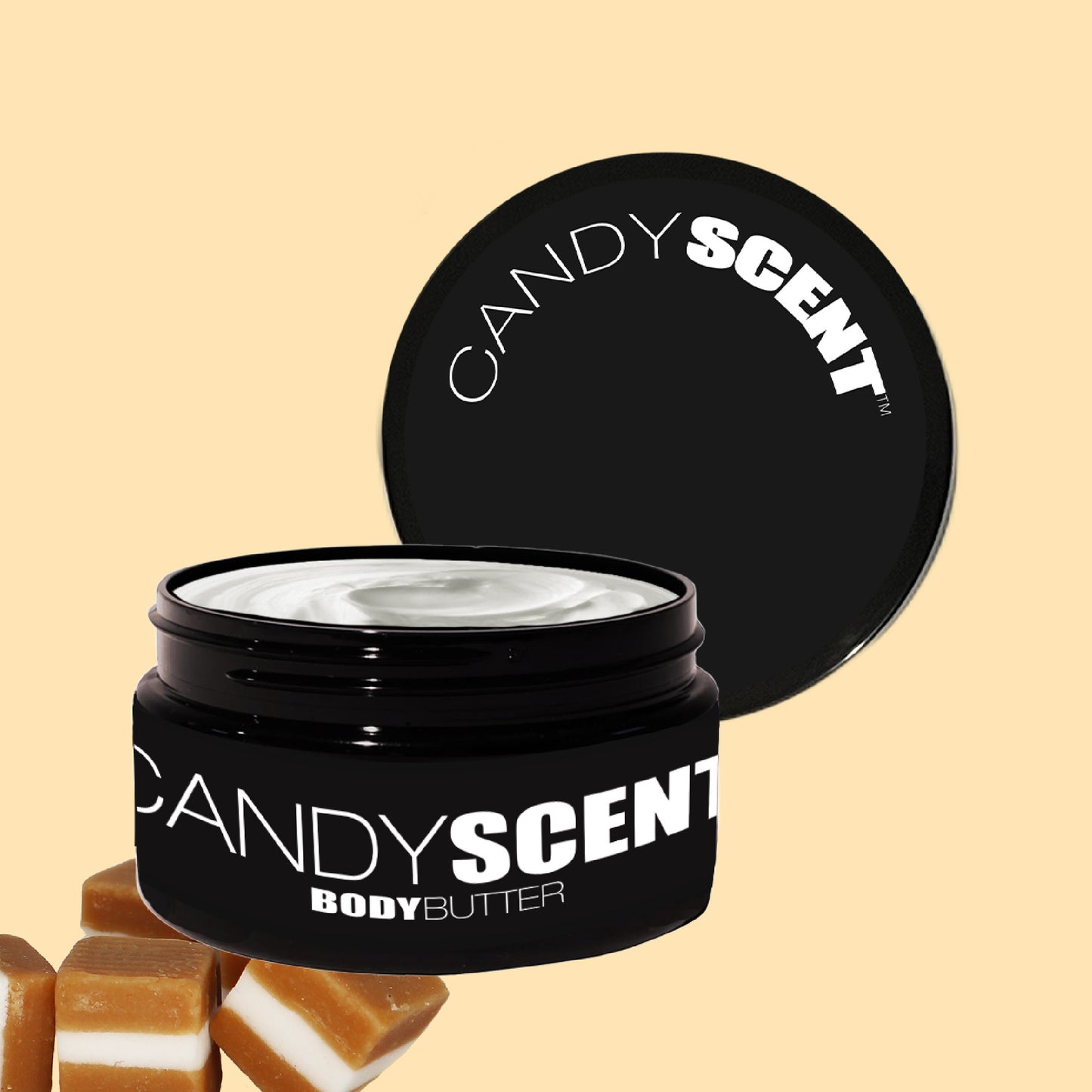 A jar of CANDYSCENT™ Body Butter with the lid open showcases its creamy texture. The black jar, featuring bold white lettering, promises nourishment and hydration. Caramel candies are placed beside it, all set against a pastel yellow background.