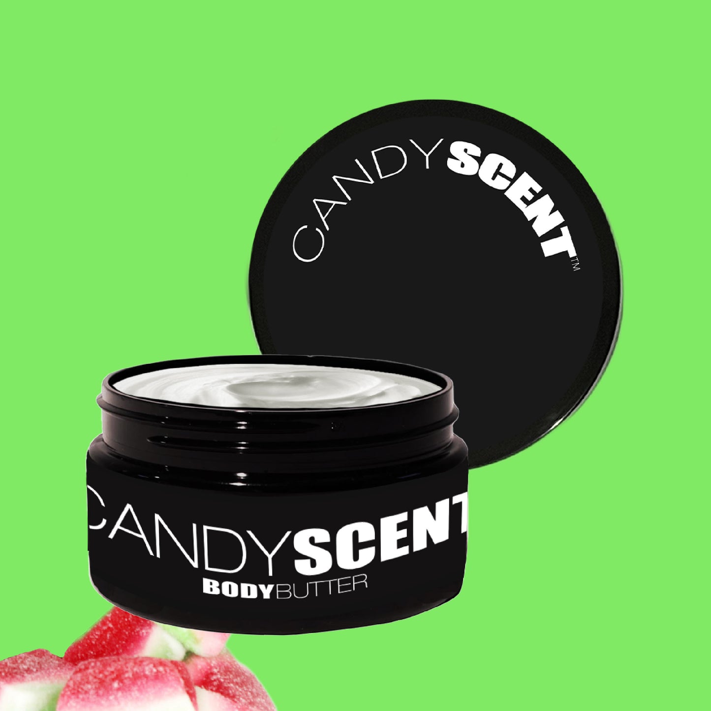 A black jar of CANDYSCENT™ Body Butter, its label clearly displaying the brand name, has its lid slightly open to unveil the creamy texture within, promising nourishment and hydration. A frosted pink candy accentuates this captivating scene against a vibrant green background.