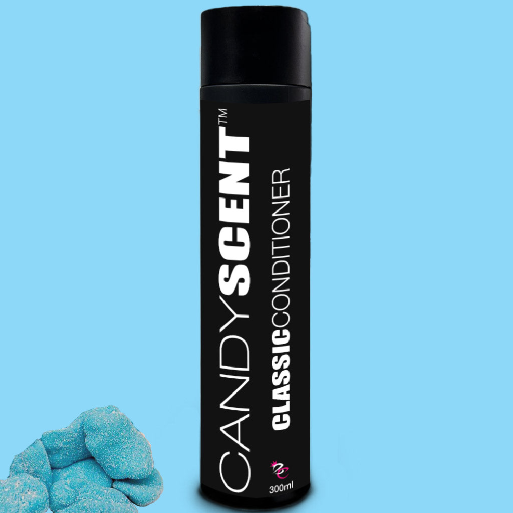 A black cylindrical bottle from the "Classic Shampoo & Conditioner Bundle" by CANDYSCENT™ stands against a blue background. To the left of the bottle are three blue, sugar-coated gummy candies. The bottle features white text and contains 300 ml of product.