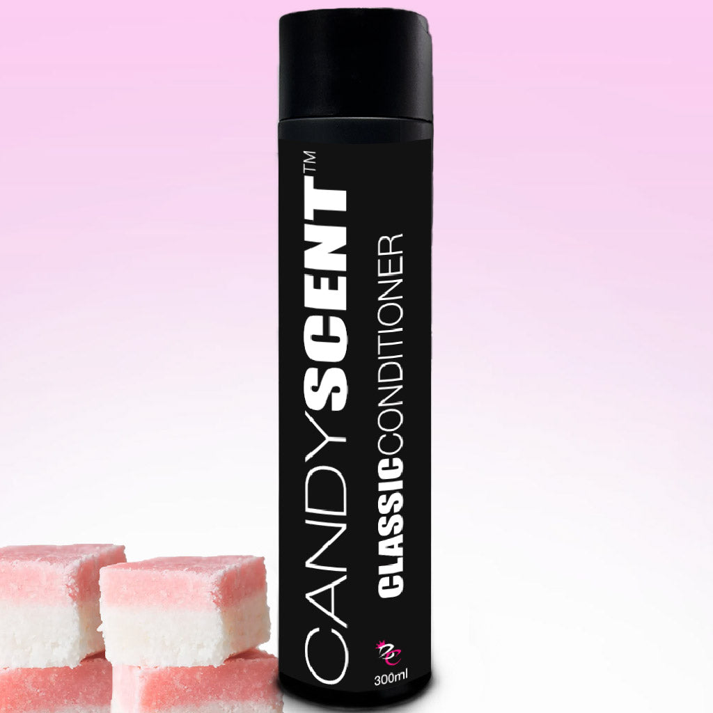 A bottle from the "CANDYSCENT™ Classic Shampoo & Conditioner Bundle" stands against a gradient pink and white background. The elegantly tall black bottle, topped with a matching black cap, features the label "Classic Conditioner." Three pink and white candy squares are artistically placed in the bottom left corner.