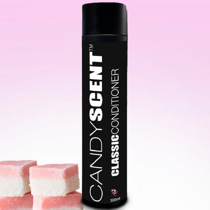 A bottle from the "CANDYSCENT™ Classic Shampoo & Conditioner Bundle" stands against a gradient pink and white background. The elegantly tall black bottle, topped with a matching black cap, features the label "Classic Conditioner." Three pink and white candy squares are artistically placed in the bottom left corner.