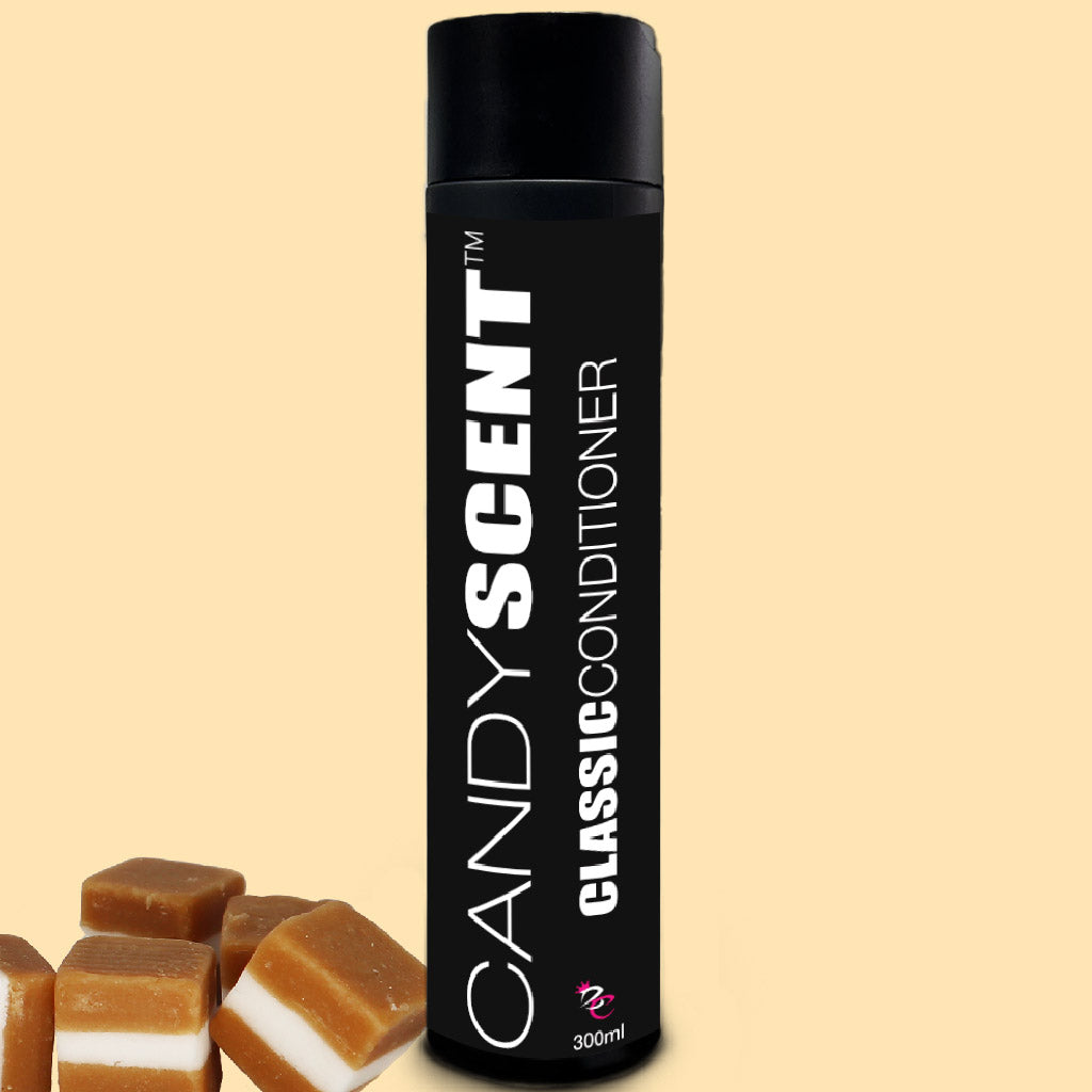 A black bottle of hair conditioner from the "Classic Shampoo & Conditioner Bundle" by CANDYSCENT™ stands upright against a beige background. In the foreground, several square caramel candies are scattered. The bottle has a capacity of 300ml.