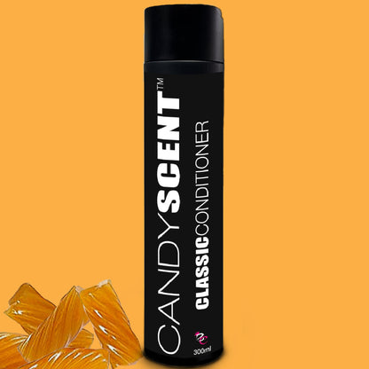 A sleek, black bottle with the text "CANDYSCENT™ Classic Shampoo & Conditioner Bundle" stands against a yellow background. At the base of the bottle, there are several translucent, orange candy-like objects. The bottle contains 300ml of product.