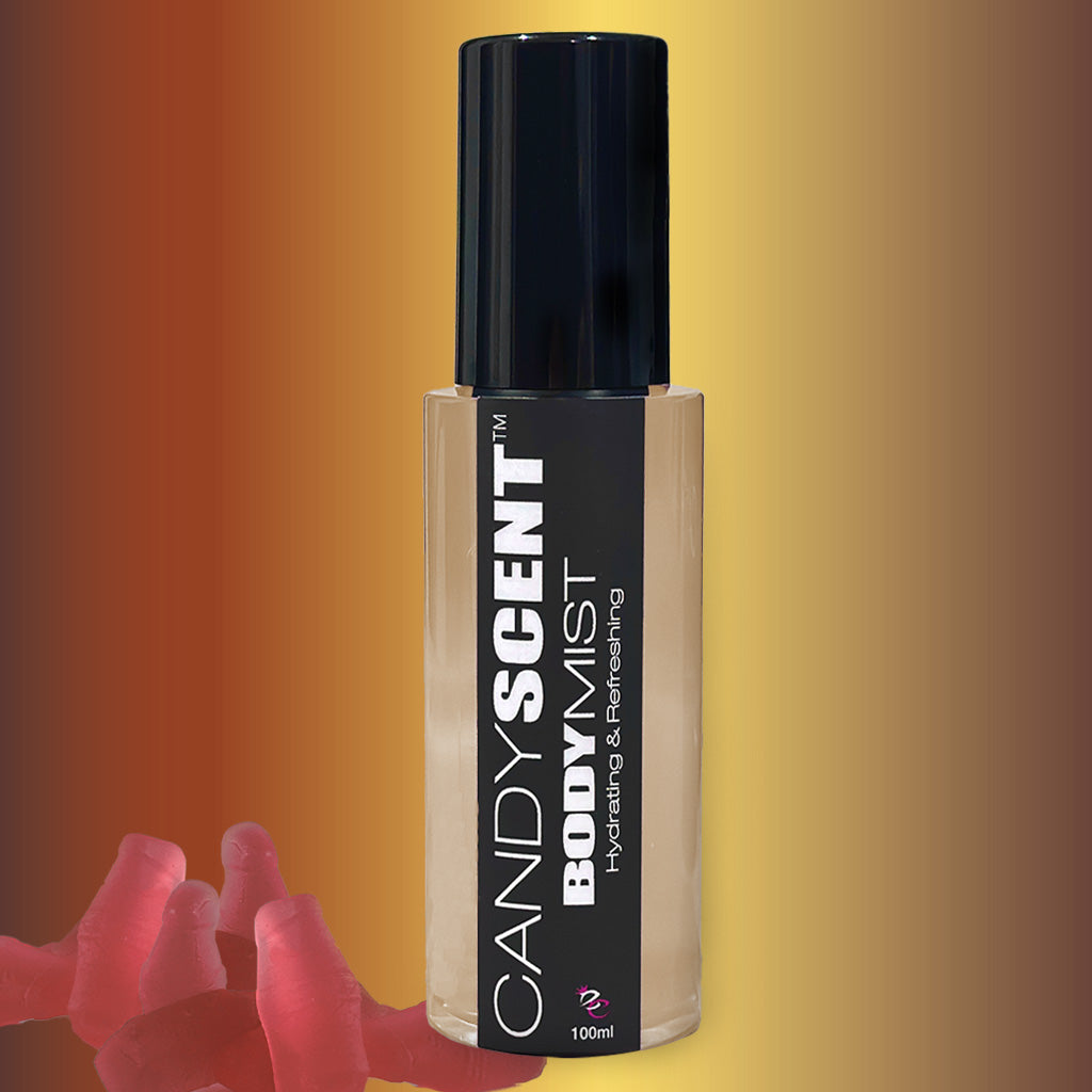 A 100ml bottle of CANDYSCENT™ Hydrating Body Mist features a black cap and a dark label showcasing the product name and the description "Hydrating & Refreshing." The backdrop is a gradient blend of brown and yellow, accentuating its nourishing ingredients like witch hazel. Red gummy bears rest near the base of the bottle.