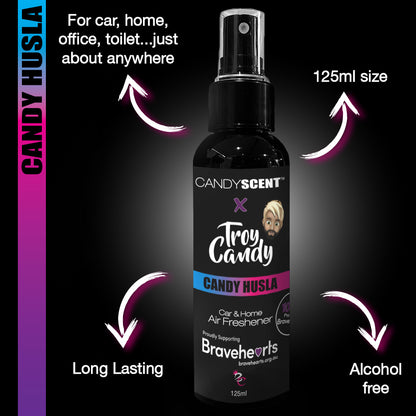 A black spray bottle labeled "Troy Candy" and "Candy Husla" is pictured. This 125ml CANDYSCENT™ x Troy Candy Car Spray air freshener from the CANDYSCENT™ brand is long-lasting, alcohol-free, and perfect for your car, home, or office. The bottle also highlights Troy Candy’s support for the Bravehearts foundation, a child protection charity.