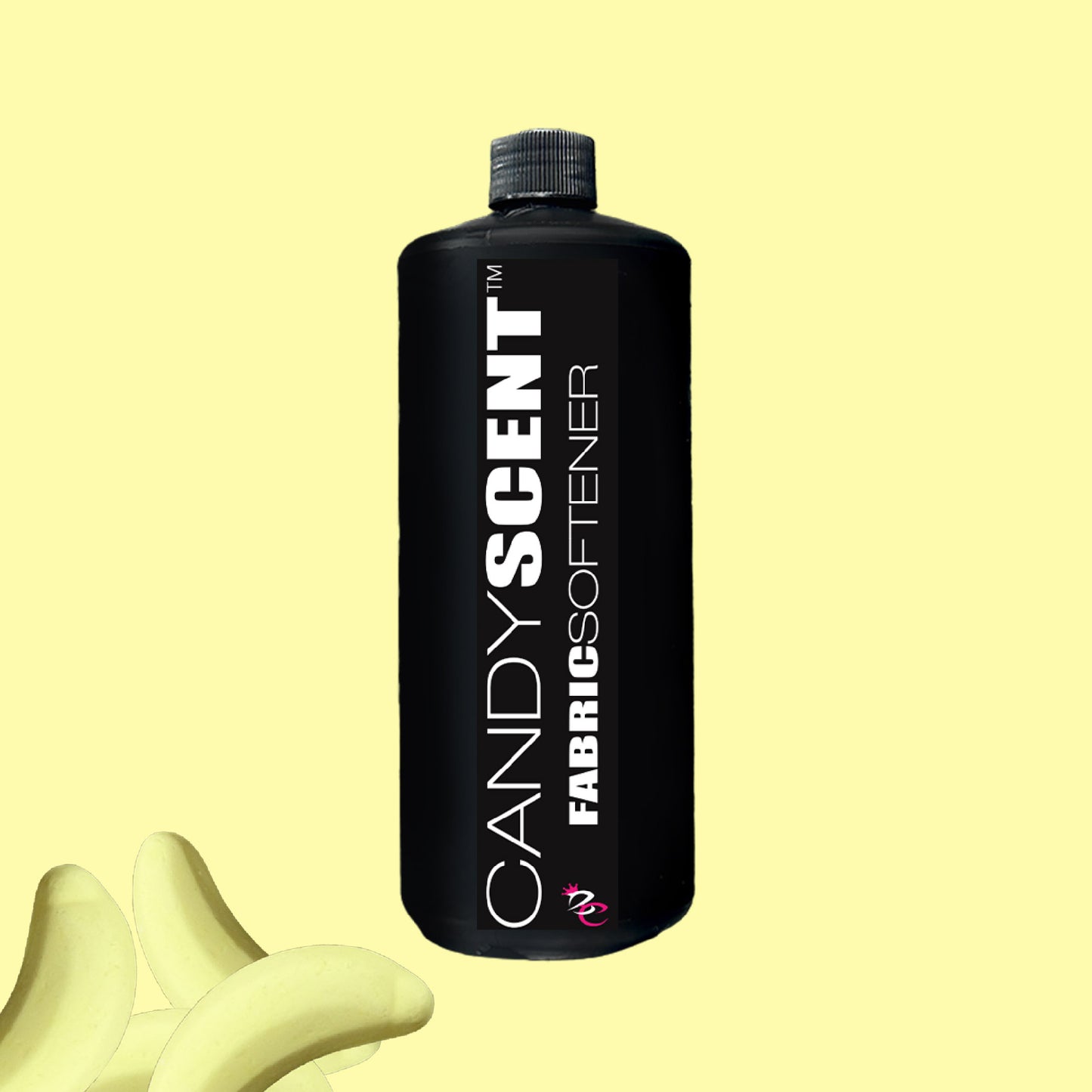 A sleek black bottle of CANDYSCENT™ Fabric Softener stands out against a pale yellow backdrop, adorned with bold white text. Nestled in the lower left corner, a scattering of banana candies adds a whimsical touch. Experience wrinkle-free and static-free freshness with every wash.