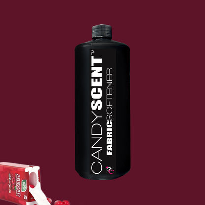 A black bottle of "Fabric Softener" by CANDYSCENT™ is positioned centrally against a dark red backdrop, offering wrinkle-free freshness. In the bottom left corner, a small white and red carton is partially visible.