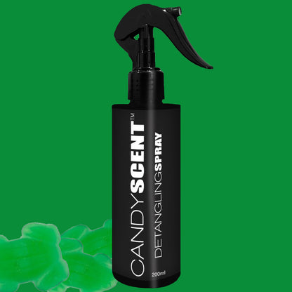 A sleek black spray bottle labeled "CANDYSCENT™ Hair Detangling Spray" with jojoba oil, and a capacity of 200ml is set against a green background. The design features white text. Mint-shaped green candies are positioned near the bottom left.