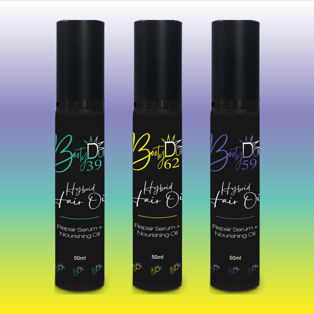 Three black bottles of Hybrid Hair Oil are arranged side by side on a gradient background. Each bottle boasts a vibrant label in green, yellow, and red respectively. The labels bear the name BOOTY DUPE with numbers 39, 62, and 59, highlighting their unique blend of repair serum and nourishing oil.