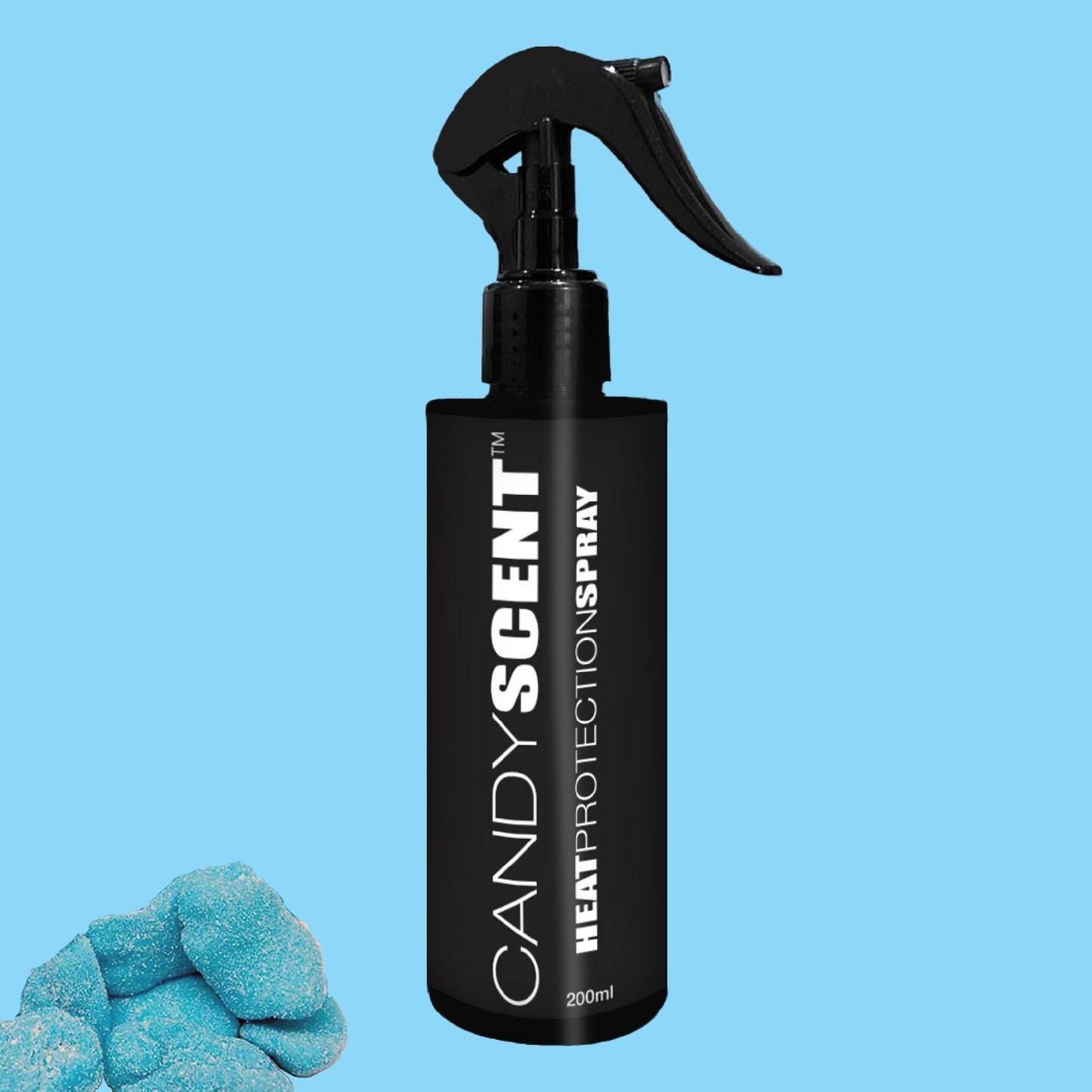 A black spray bottle labeled "CANDYSCENT™ Heat Protection Spray" (200ml) is centered against a blue backdrop. On the left, blue sugar-coated candies add a touch of charm, suggesting salon-quality results.