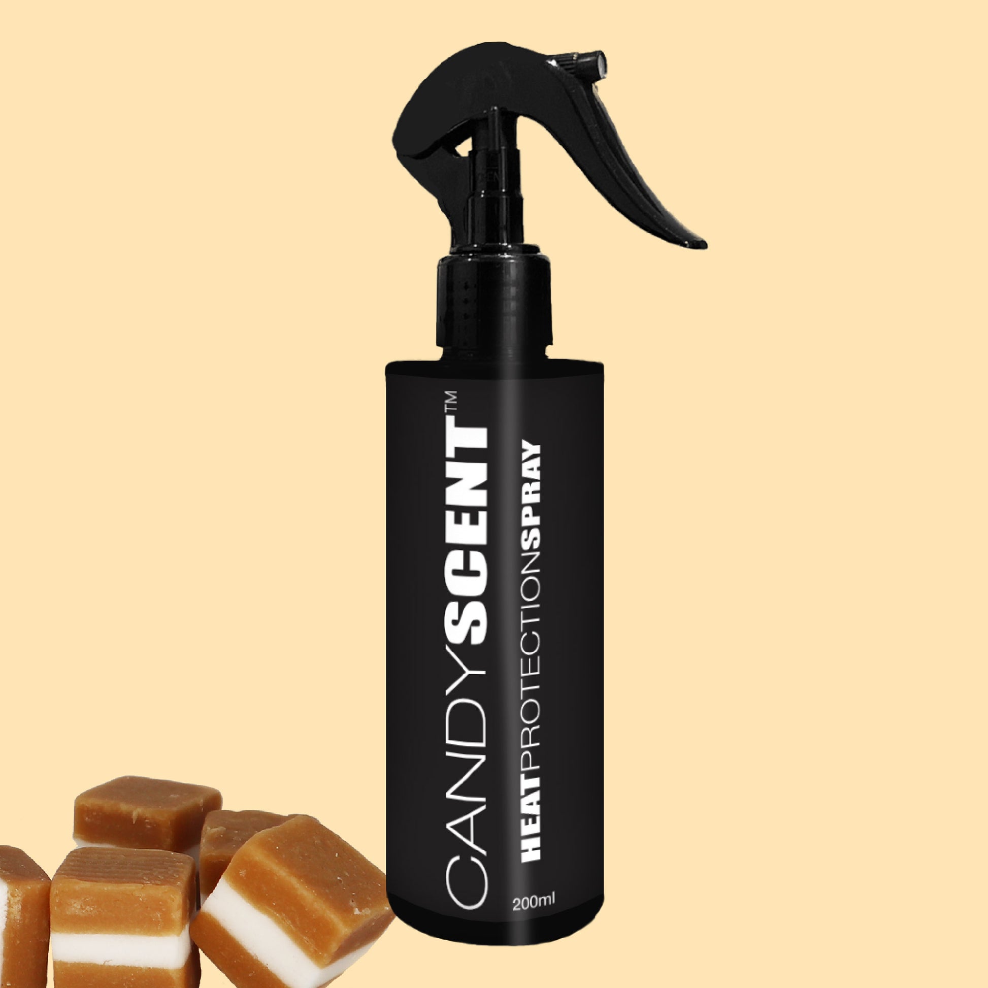 A black spray bottle labeled "CANDYSCENT™ Heat Protection Spray" is set against a light yellow background, promising salon-quality results. Beside the bottle are three caramel candies, suggesting the sweet scent contained within this 200ml product.