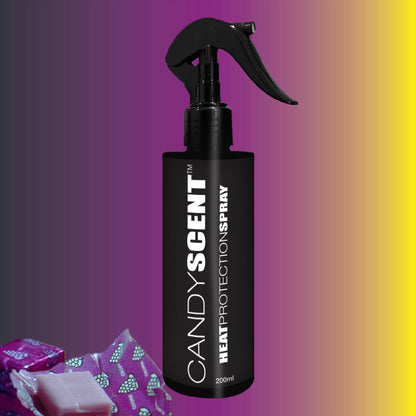 A black spray bottle labeled "CANDYSCENT™ Heat Protection Spray" is set against a gradient background transitioning from pink to yellow, offering promises of salon-quality results. Two small wrapped items at the bottom left corner emphasize its role in strengthening hair.