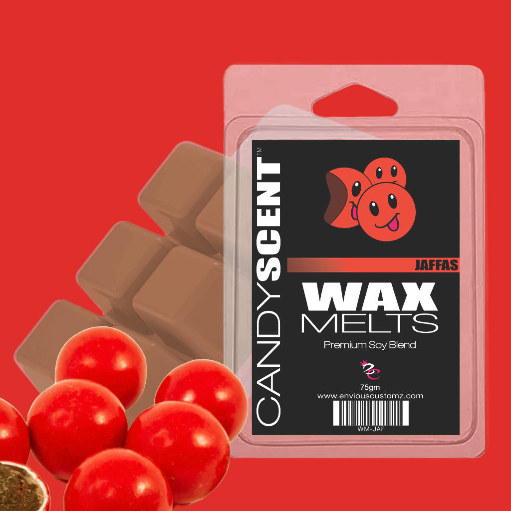 A package of "(DISCONTINUED CANDYSCENT™'S) Wax Melts" with the label "Jaffas" is shown against a vivid red backdrop. The packaging displays a whimsical design featuring chocolate and orange candies, promising an enjoyable home fragrance experience. Beside it are pieces of chocolate and vibrant red candy balls.