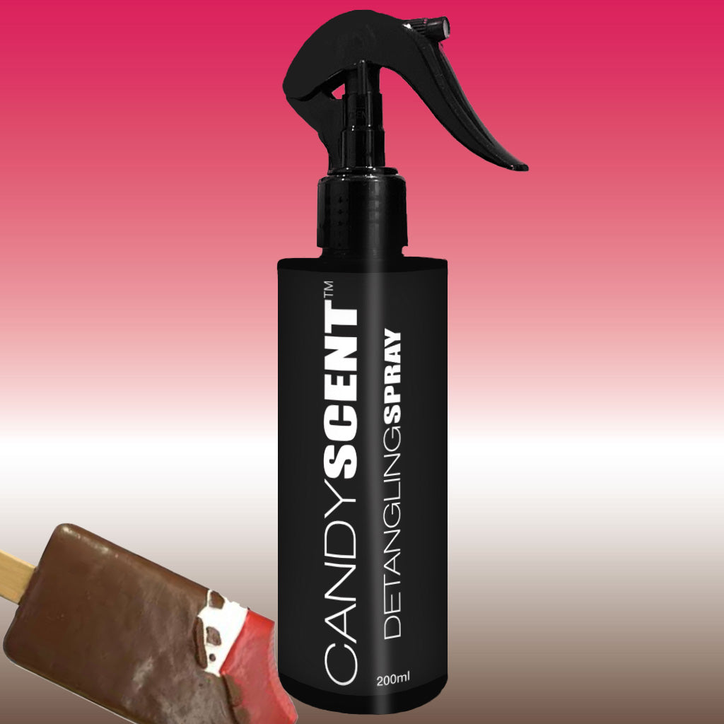 A black spray bottle bearing the label "CANDYSCENT™ Hair Detangling Spray 200ml" is featured prominently against a gradient backdrop transitioning from pink at the top to white at the bottom. Infused with jojoba oil and aloe vera, this spray promises effortless hair detangling. In the bottom left corner, a partially visible chocolate-covered ice cream bar adds to the visual appeal.